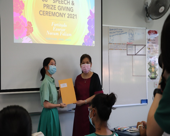 TKGian receiving certificate from Vice-Principal during the 2021 Prize Giving Ceremony.